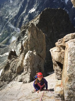 Louise climbing with her red helmet