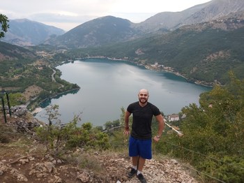 Mohammad on a hiking trail overlooking a lake
