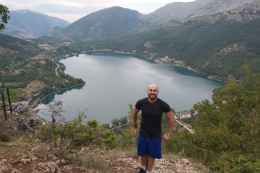 Mohammad on a hiking trail overlooking a lake