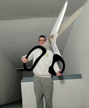 A photoshpped image of Adrien holding gigantic scissors
